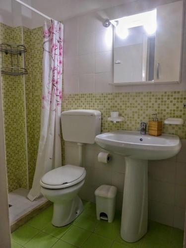a bathroom with a toilet and a sink at Maison Vivian Apartment in Marzamemi