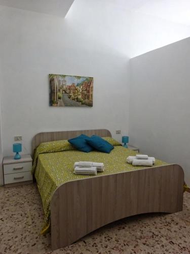 a bedroom with a bed with two towels on it at Maison Vivian Apartment in Marzamemi