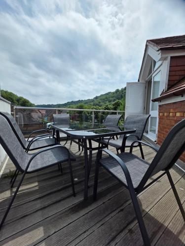 a patio with a table and chairs on a deck at Number 1 School Path in Coalbrookdale