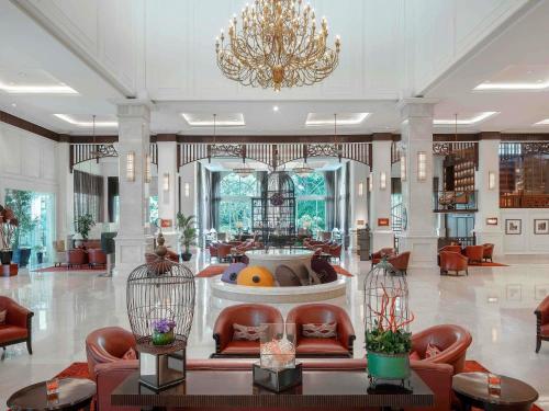 a lobby with a fountain in the middle of a building at Sofitel Phnom Penh Phokeethra in Phnom Penh
