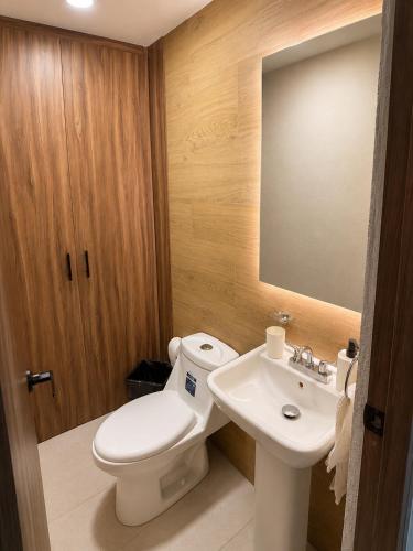 a bathroom with a toilet and a sink at Casa Cholula in La Concepción