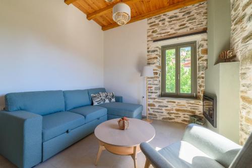 a living room with a blue couch and a table at Orange House - Upper East apartment in Promírion