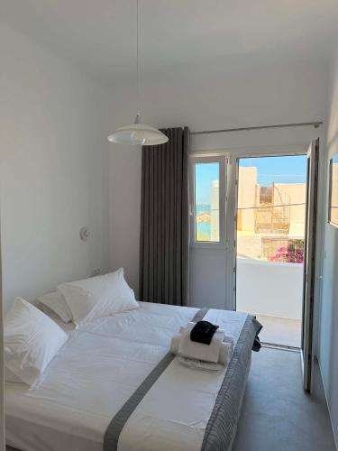 a white bed in a room with a window at Busho Residence 1 in Naousa