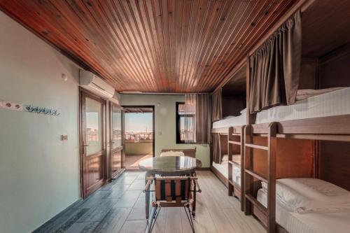 a room with bunk beds and a table in it at YOLO Hostel in Istanbul