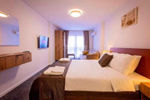 a bedroom with a large bed in a room at Gegë Boutique Hotel in Gjakove