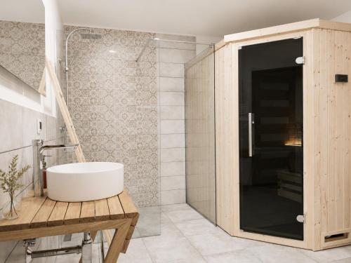 a bathroom with a white tub and a shower at Sosnowy Taras in Koszele