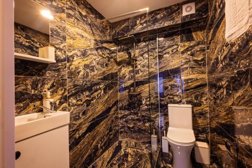 a bathroom with a toilet and a sink at Gegë Boutique Hotel in Gjakove