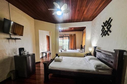 a bedroom with a bed and a ceiling fan at Tabulia Tree Hotel and Villas in Manuel Antonio