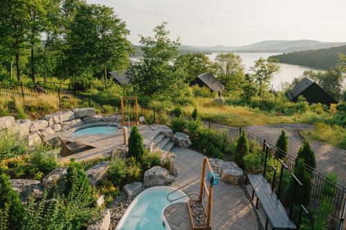 a backyard with a swimming pool and a playground at Duchesnay - Sepaq in Sainte-Catherine