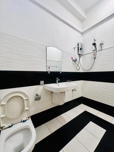 a bathroom with a toilet and a sink at Panda House in Galle