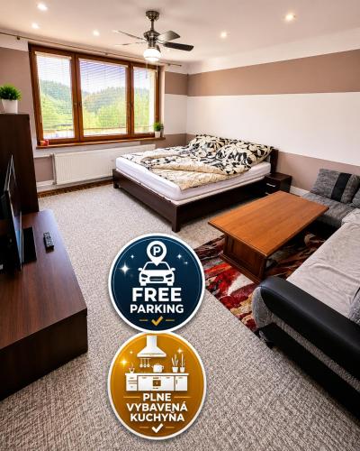 a large living room with a free parking sign in it at APARTMAN WOLF Luxusné priestranné ubytovanie s Výhľadom na hory s Bezplatným Parkovaním Veľkou SMART TV Rýchlym Optickým Internetom Priamo v PB Tichá lokalita Všetko na blízku Vhodné pre Rodinu Skupinu Pracovné cesty aj Turistiku Plne vybavená Kuchyňa in Považská Bystrica