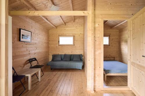 a room with a bed and a couch in a cabin at Jūros terasos in Šventoji