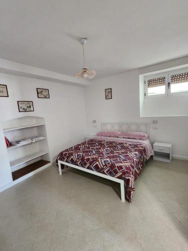 a bedroom with a bed and two windows at Casa Annina in Basilicata in Trivigno