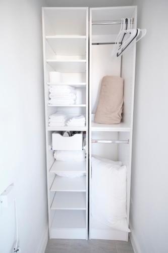 a closet with white shelves and white towels at Waterfront Cabana 3 Key Largo in Key Largo