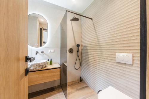 a bathroom with a shower and a sink at Odat n'Bogë - Breakfast Included by PikHost in Bogë