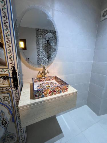 a bathroom with a sink and a mirror at Casa El Haouta in Chefchaouen