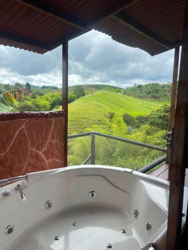 a bath tub in a room with a view at Hotel Cabañas Del Quindio in Filandia