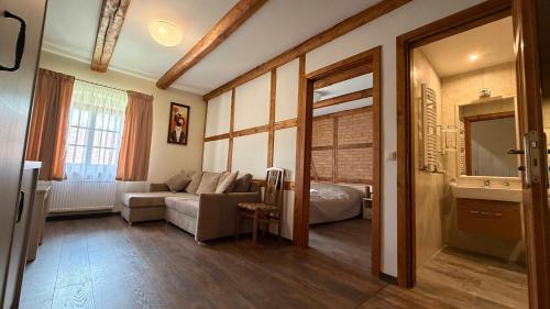 a living room with a couch and a bed in a room at Agroturystyka Folwark Natura in Wleń