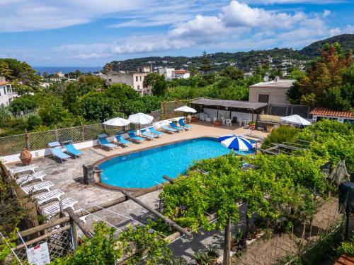 a swimming pool with lounge chairs and umbrellas at Residence Parco Gioconda in Forio d'Ischia