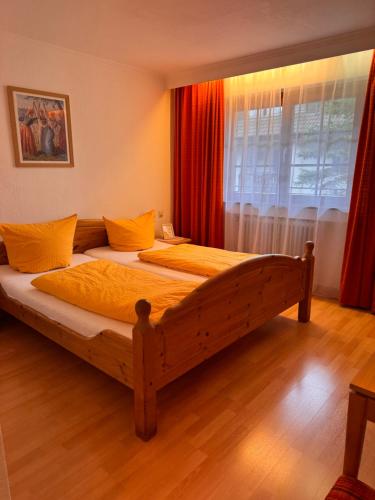 a bedroom with two beds and a window at Hotel-Restaurant Maien in Todtmoos