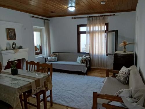 a living room with a table and a couch at Heidis Haus in Polygryos
