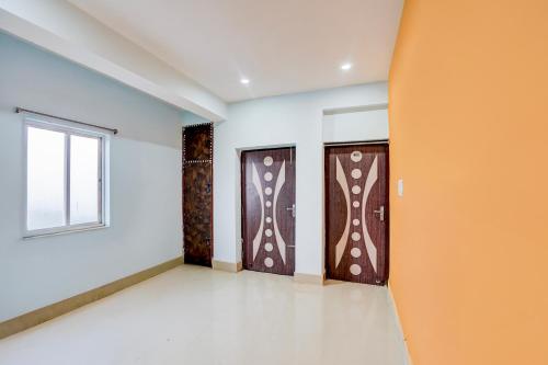 an empty room with two doors and a window at Hotel O Royal Inn Hotel in Dīgha