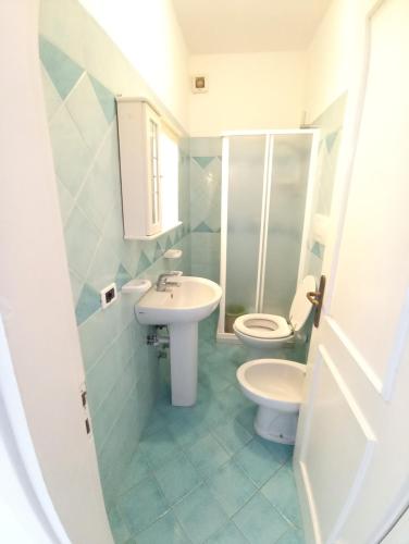 a bathroom with a toilet and a sink at GRomano Apartments in Ischia Town