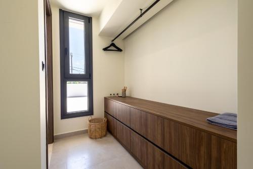 a room with a wooden wall and a window at Noera Villas in Kremasti