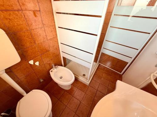 a bathroom with a toilet and a sink at Vear Hausing - Volano 80 int 8 in Lido di Volano