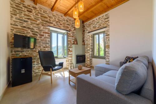 a living room with a couch and a brick wall at Orange House - Upper West apartment in Promírion