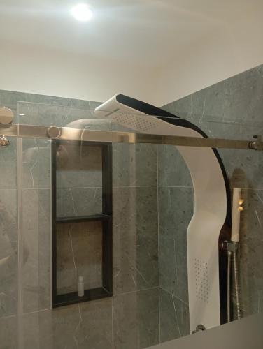 a hairdryer sitting on top of a shower at Sabry holiday Terrasini in Terrasini