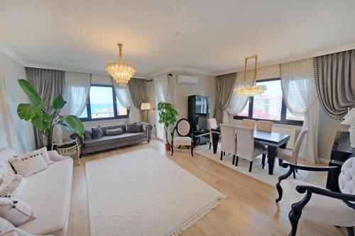 a living room with a couch and a dining room at Zumra's White Houses in Trabzon