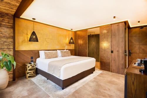 a bedroom with a bed and a walk in shower at Golden Valley Hotel in Medellín