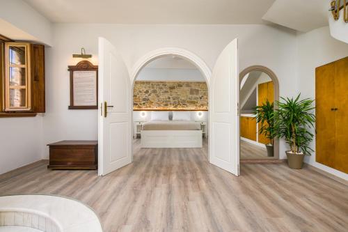 a bedroom with a bed and an open door at Old Town Tower House in Kos