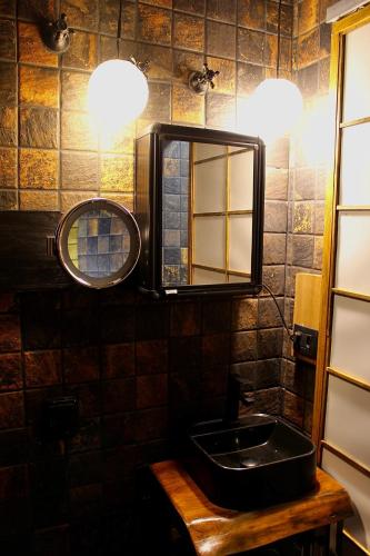 a bathroom with a sink and a mirror at Ryokan in São Paulo