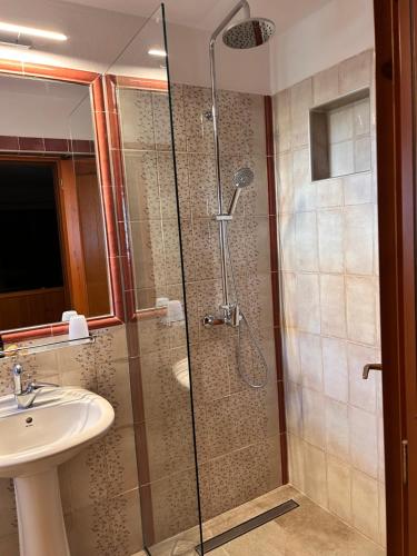 a bathroom with a shower and a sink at Del Sol Skopelos in Skopelos Town