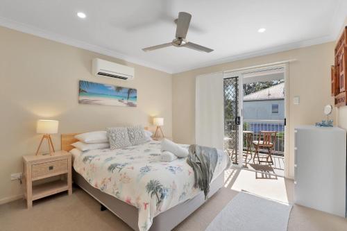 a bedroom with a bed and a balcony at Flip Flop Inn in Amity Point