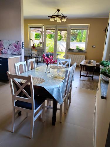 a dining room with a table and chairs and a kitchen at Brzask in Mosty