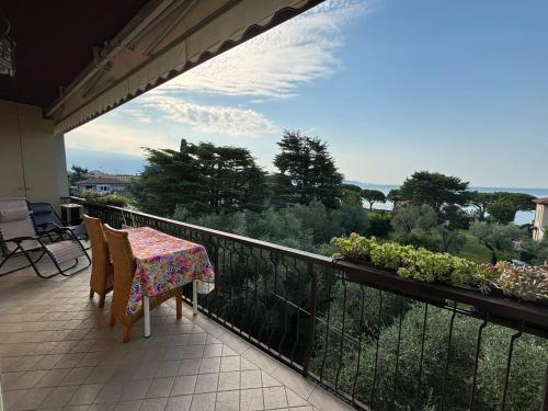 a balcony with a table and chairs and a view at Casa Cristina Giulia in Toscolano Maderno
