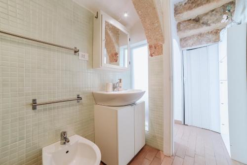 a bathroom with a sink and a toilet at A L Tourist House - La Corte di Cavuor in Monopoli