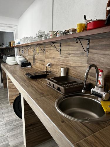 a kitchen with a sink and a wooden counter top at Vikendica Vesic Tegare in Bratunac
