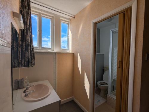 a bathroom with a sink and a toilet at Areawest in Scarborough