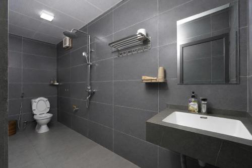 a bathroom with a sink and a toilet and a mirror at Tam Coc Aurora Valley in Vũ Lâm