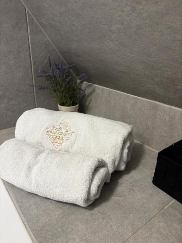 a bathroom with two white towels on a counter at Nase Chaty- domki z balią, termy i natura in Biały Dunajec