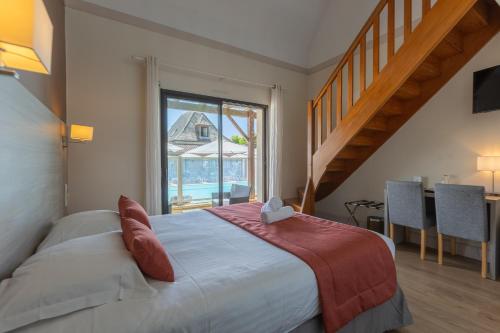 a bedroom with a bed and a large window at L'Oustal de Vézac in Vézac