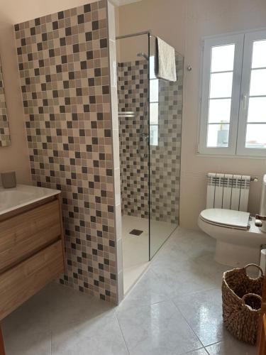 a bathroom with a shower and a toilet and a sink at Villa Vistamar - Piscina privada, vistas al mar y a 5 min de la playa in Cala en Porter