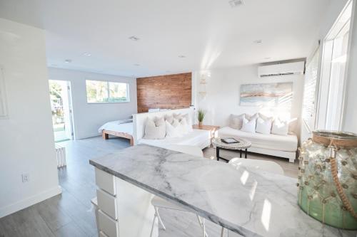 a living room with white furniture and a marble table at Waterfront Cabana 5 Key Largo in Key Largo