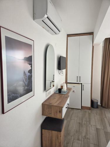a bathroom with a sink and a refrigerator at CARETTA PANSİYOn in Kaş