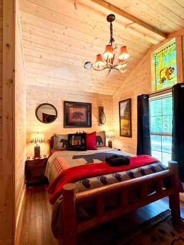 a bedroom with a bed in a wooden room at Big Bear Log cabin in Cosby