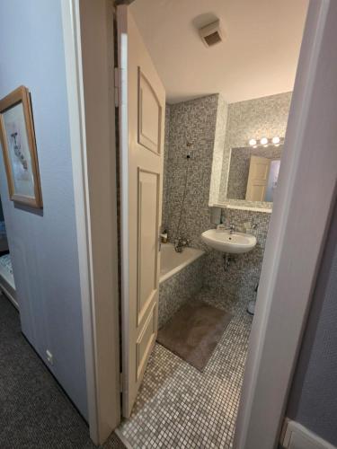 a bathroom with a sink and a tub and a toilet at Nicava in Nīca